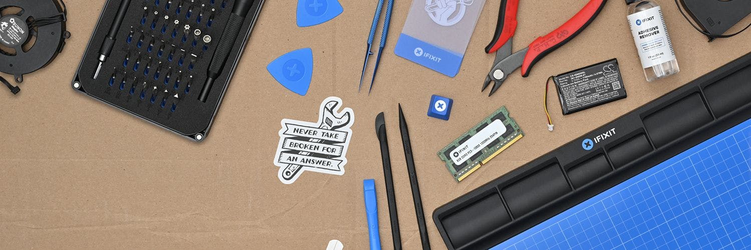 Assortment of iFixit's tools displayed on a cardboard background.